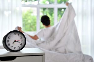 Busy parent waking up early to fit in a morning workout before the day starts.